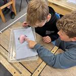 Children looking at a chicken wing