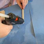 Boy using glue gun